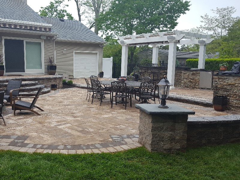 backyard patio with seating walls, bar island and kitchen island